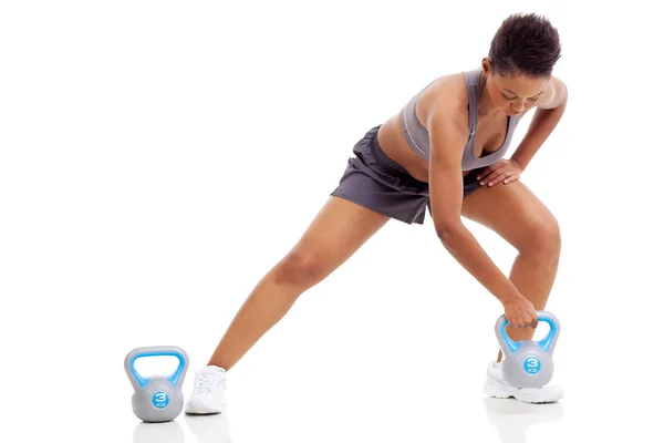 African woman exercising using kettle bell Stock Photo