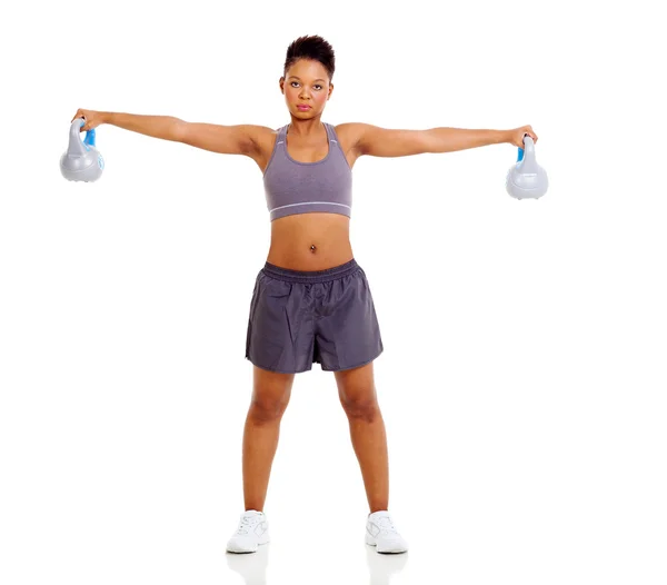 Fit african woman lifting kettle bell Stock Picture