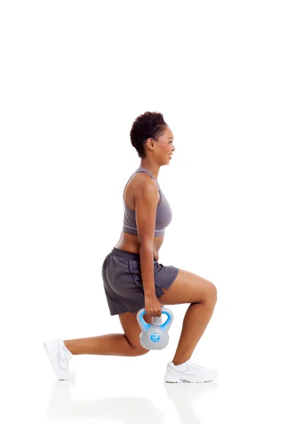 African woman instructor exercising using kettle bell Stock Image