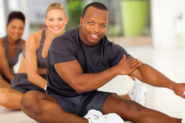 African man with team stretching before exercise — Stock Photo, Image