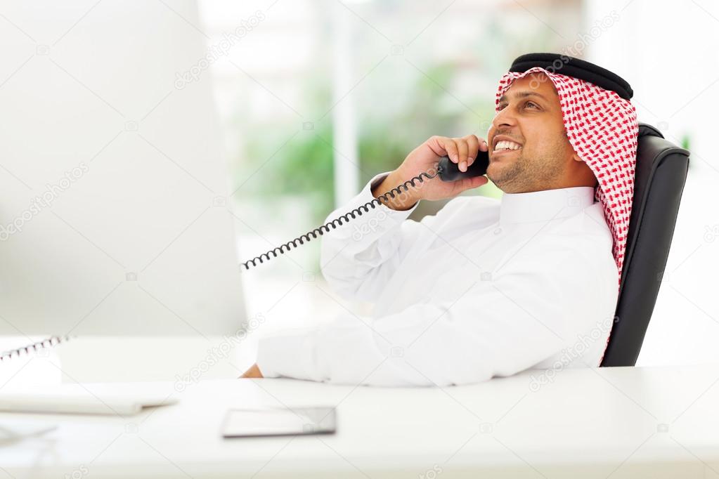 arabian corporate worker talking on the phone