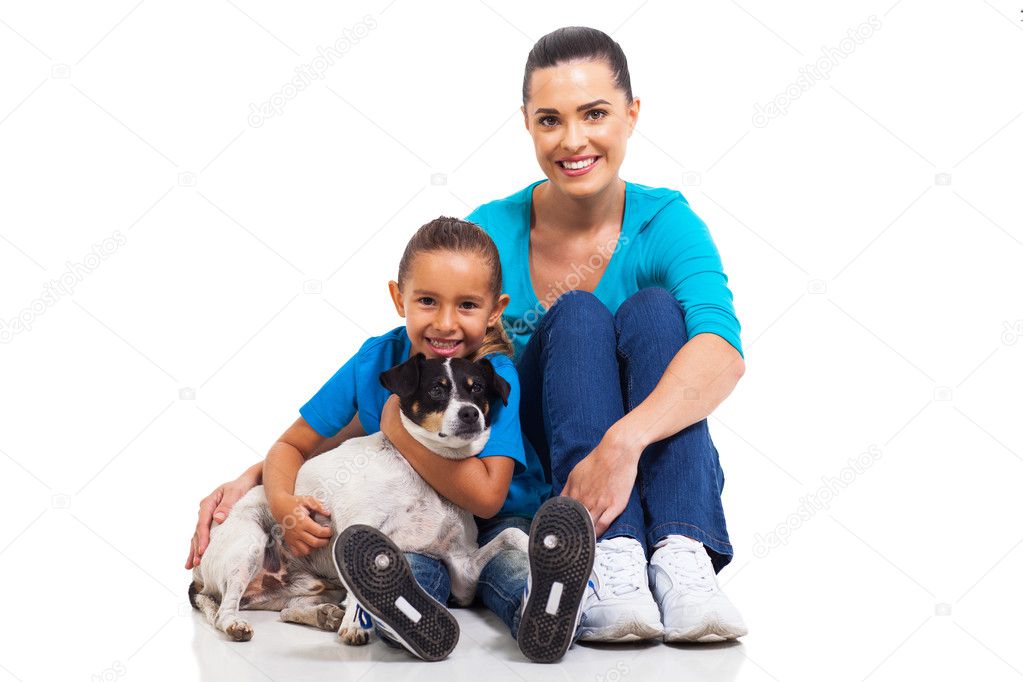 joyful mother sitting with little daughter and pet dog