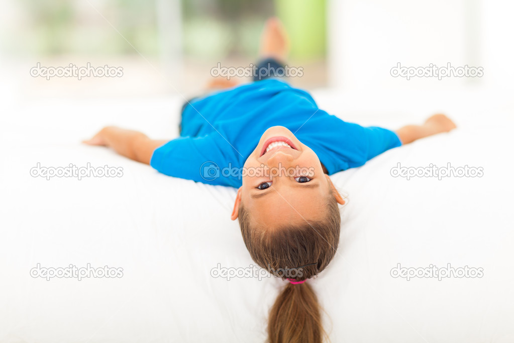 adorable little girl lying on bed
