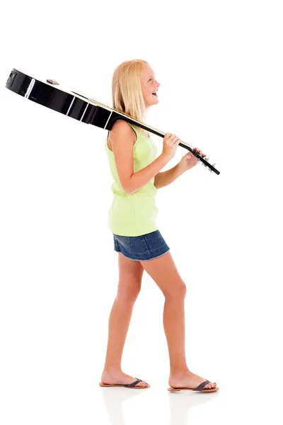Side view of young preteen girl carrying a guitar — Stock Photo, Image