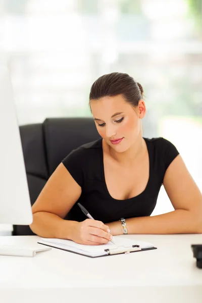 Business woman writing report Stock Photo