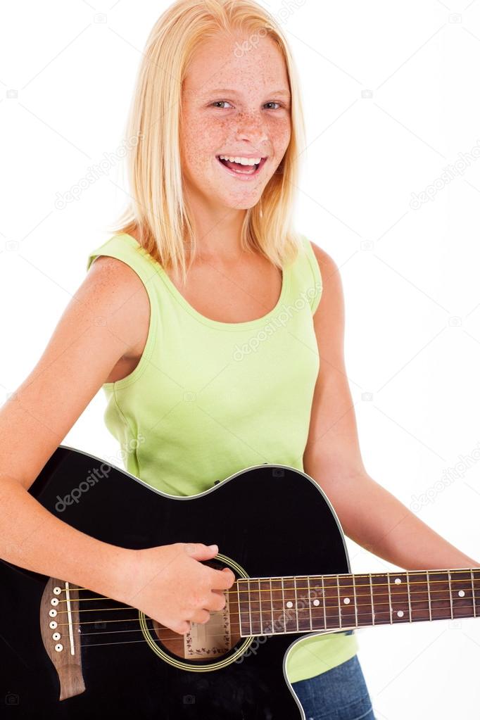 pre teen girl playing a guitar