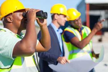 construction worker using binoculars