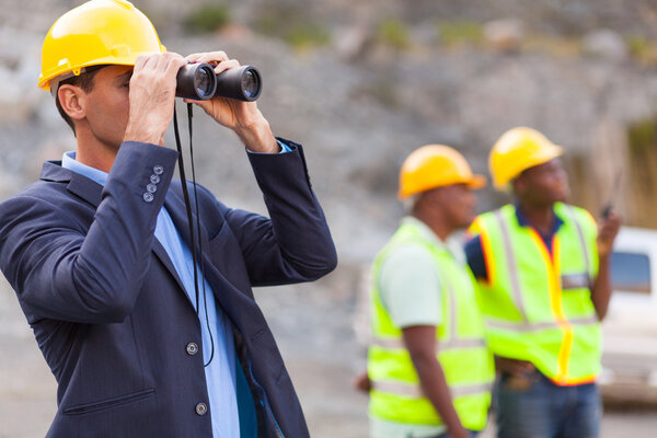 mine manager with binoculars