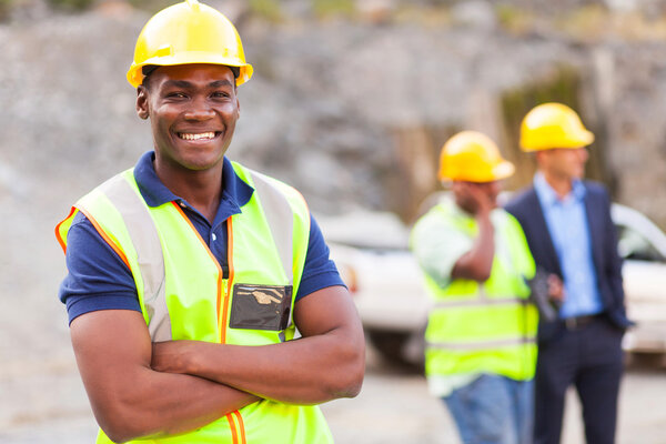 african industrial worker with arms folded