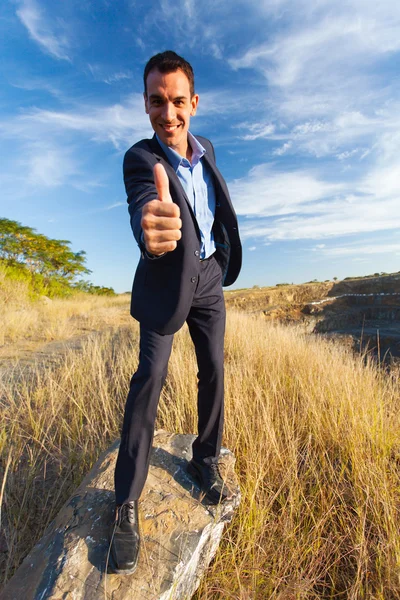 Young successful businessman giving thumb up — Stock Photo, Image