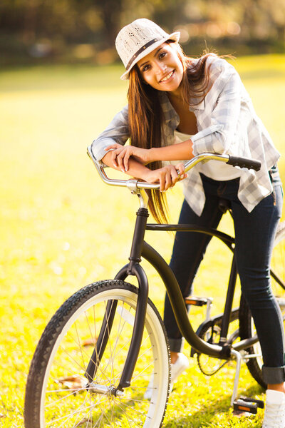 young woman posing on a bike