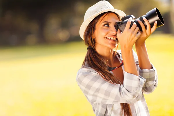 Young female photographer taking pictures Stock Photo