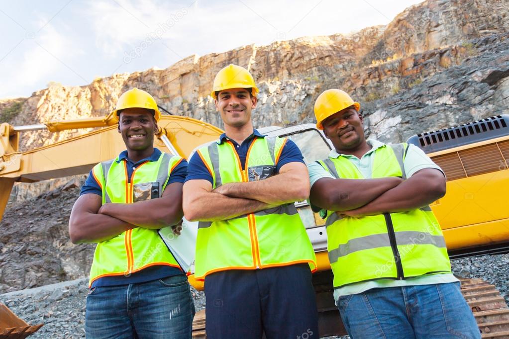 quarry workers standing with arms crossed