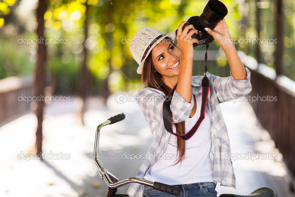 young woman taking photos outdoors