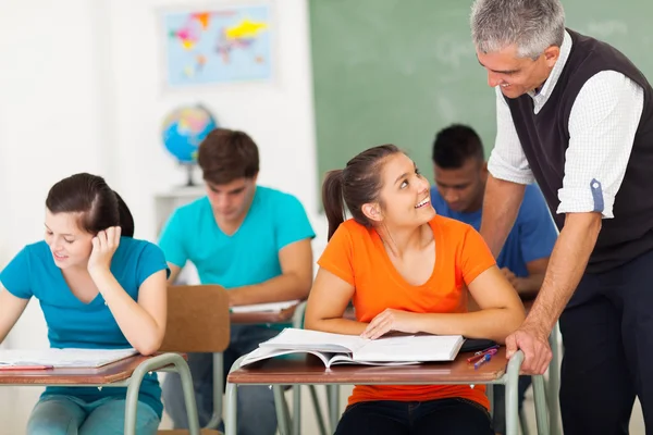 Senior high school teacher talking to student — Stockfoto