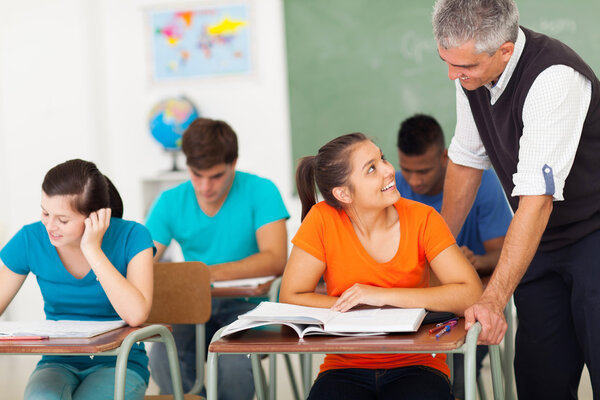 senior high school teacher talking to student