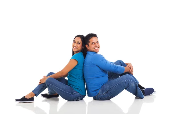 Young indian couple sitting back to back — Stock Photo, Image