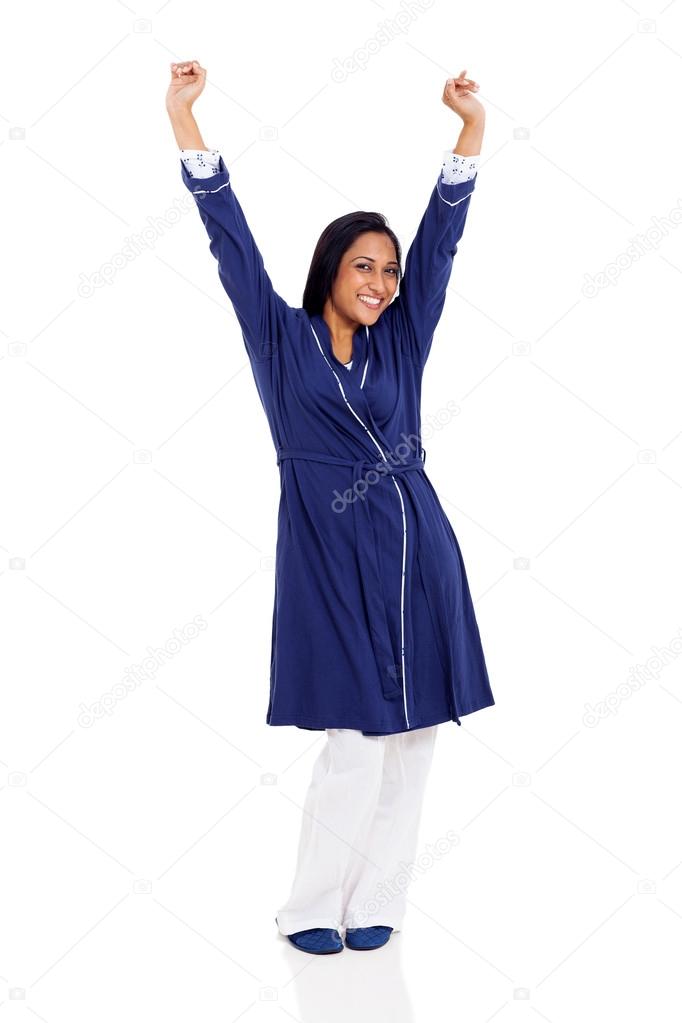 indian woman in pajamas stretching in the morning