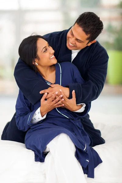 Lovely indian couple embracing on bed — Stock Photo, Image