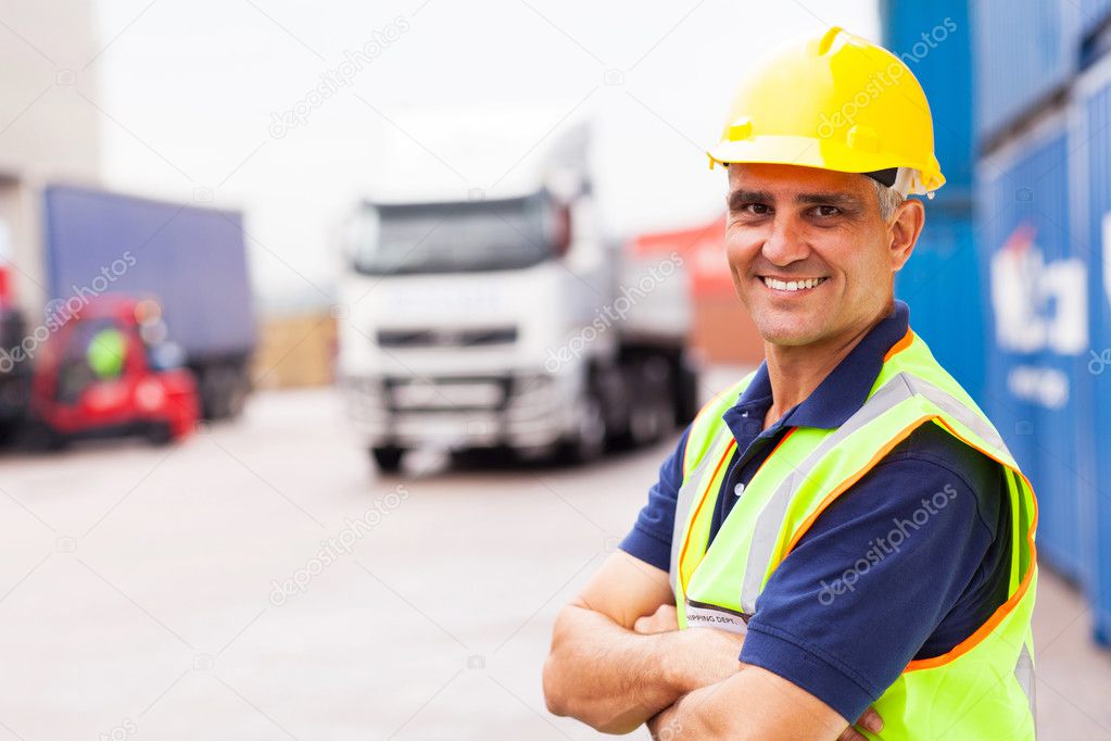 senior shipping company worker standing outside warehouse