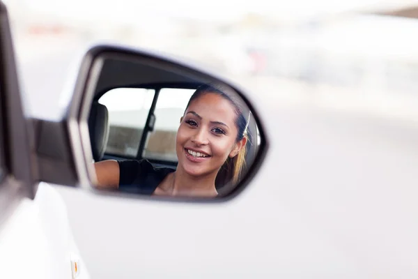 Young businesswoman driver looking at side mirror — Stock Photo, Image