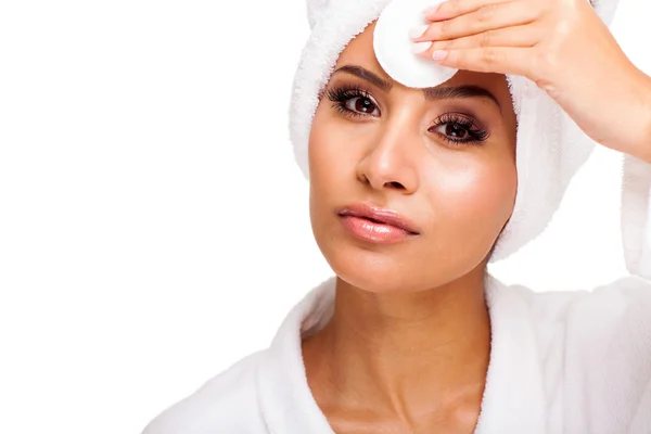 Beautiful young woman with cotton pad wiping her forehead — Stock Photo, Image