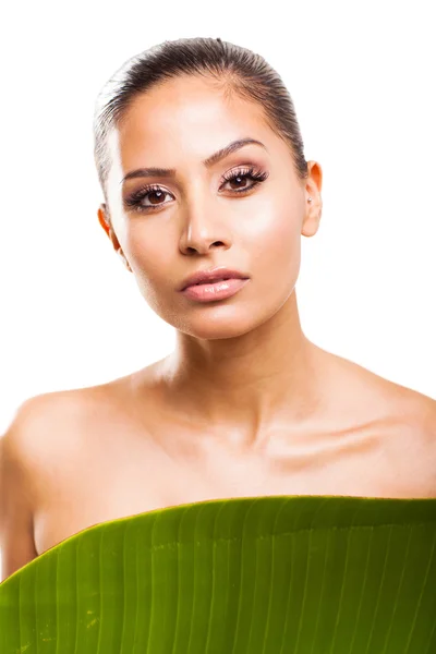 Young woman standing behind green leaf — Stock Photo, Image