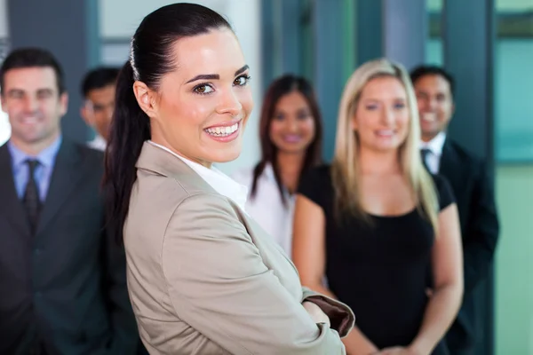 Businesswoman in office with co-workers — Stock Photo, Image