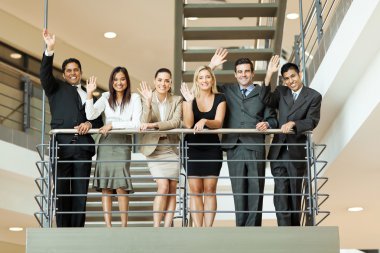 Business people waving at stairway