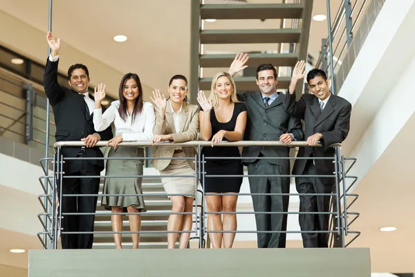 Business people waving at stairway — Stock Photo, Image