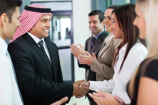 Group of business team welcoming arabian businessman — Stock Photo, Image