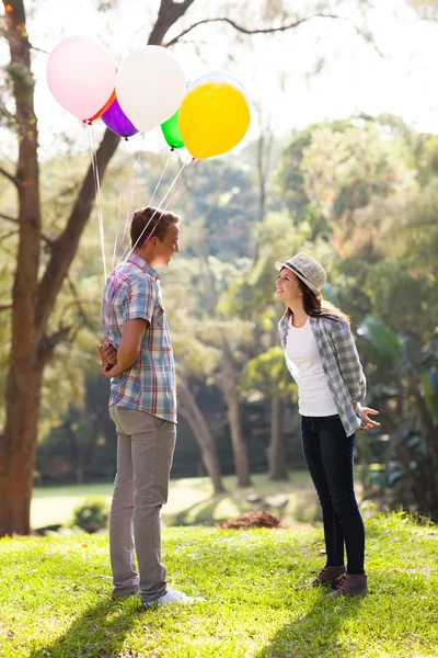 Romantic teen boy with helium balloons — Stock Photo, Image