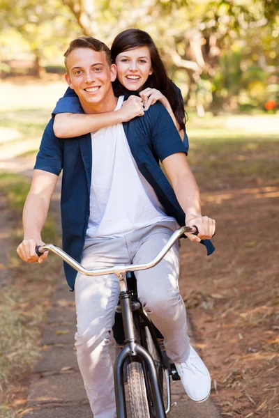 Teen couple having fun riding a bicycle — Stock Photo, Image