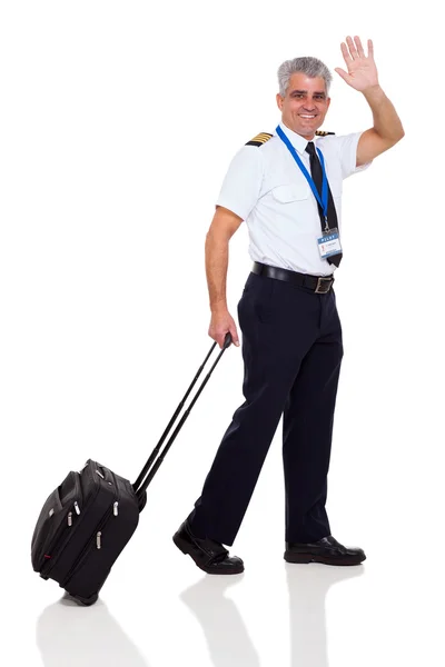 Mid age airline pilot waving goodbye — Stock Photo, Image