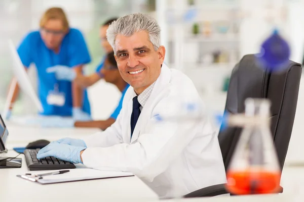 Técnico de laboratorio senior que trabaja en la computadora — Foto de Stock