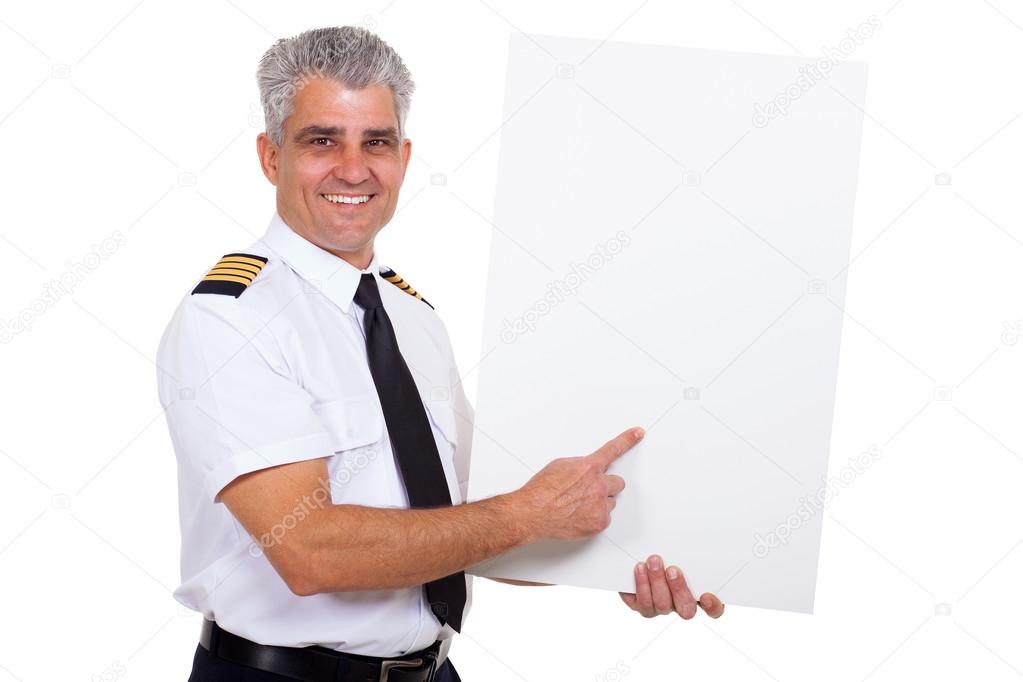 middle aged airline captain pointing at blank white board
