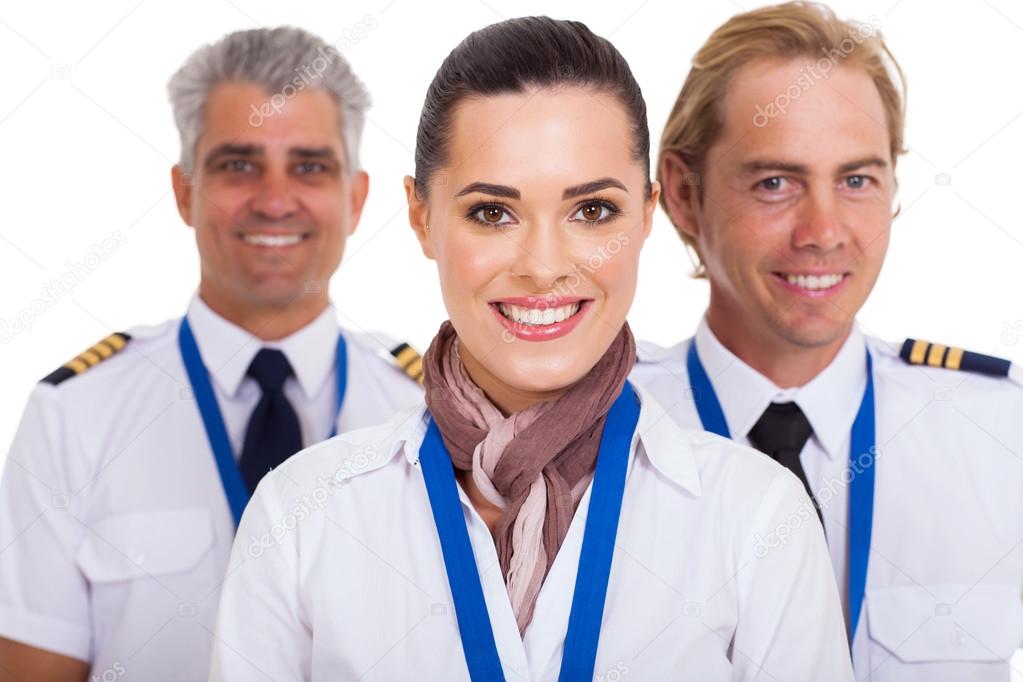 flight attendant standing in front of pilots