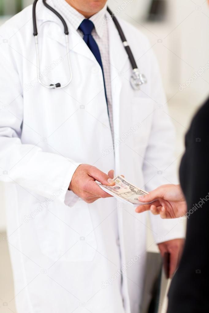 male doctor receiving money from a patient