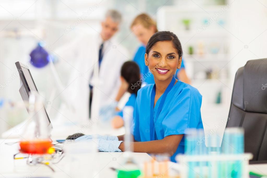 indian laboratory worker using computer