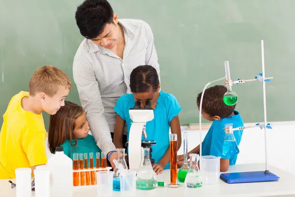 Primary teacher and students in science class — Stock Photo, Image