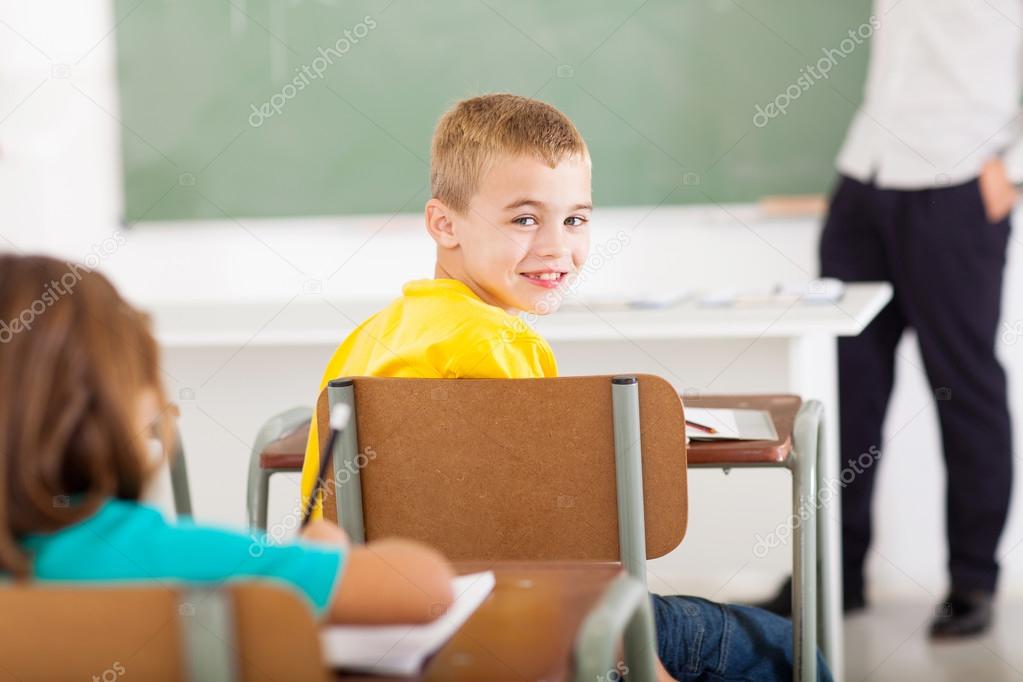 primary school student looking back in classroom