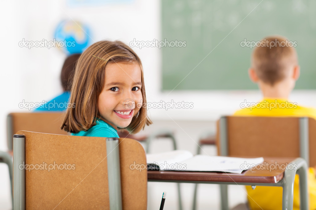 adorable little schoolgirl in classroom