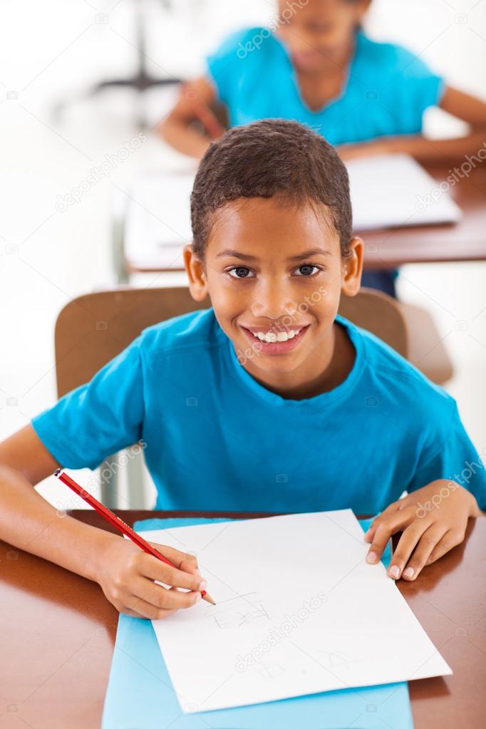 african schoolboy writing classwork
