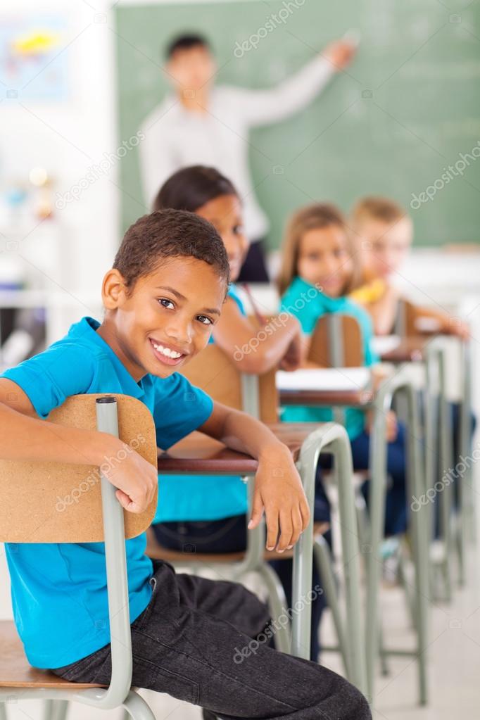 elementary school boy in classroom looking