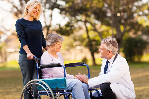 Médecin masculin parlant avec une femme âgée handicapée — Photo