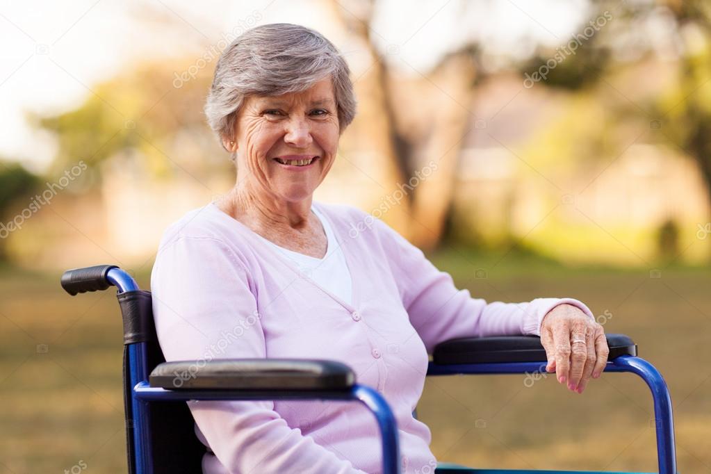 senior woman sitting on wheelchair outdoors
