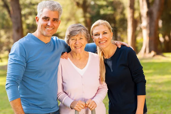 Mid age couple and senior mother outdoors — Stock Photo, Image