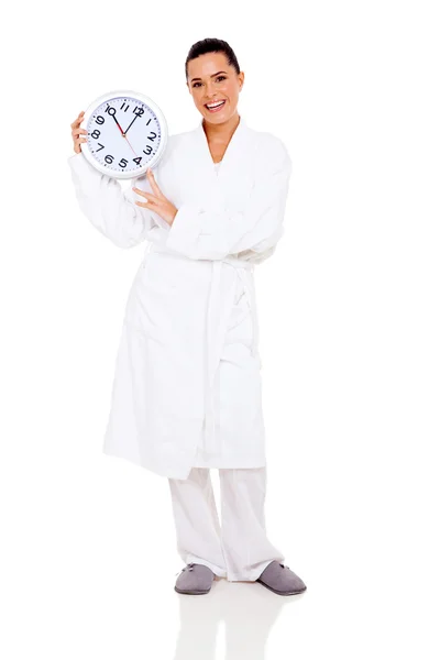 Mujer joven en albornoz celebración del reloj — Foto de Stock