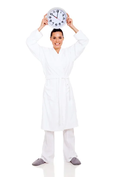 Young woman with a clock on her head — Stock Photo, Image