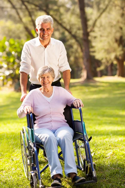 Caring mid age son taking senior mother for a walk Royalty Free Stock Photos